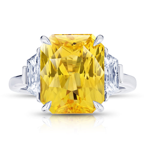 10.53 carat Emerald Cut Orange Sapphire with two Trapezoid Step Cut Diamonds in a Platinum ring