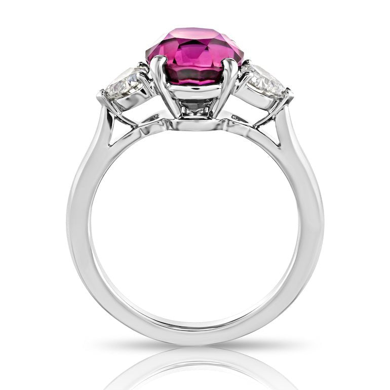 4.49 carat Oval Pink Sapphire with two Heart Diamonds in a Platinum ring - David Gross Group