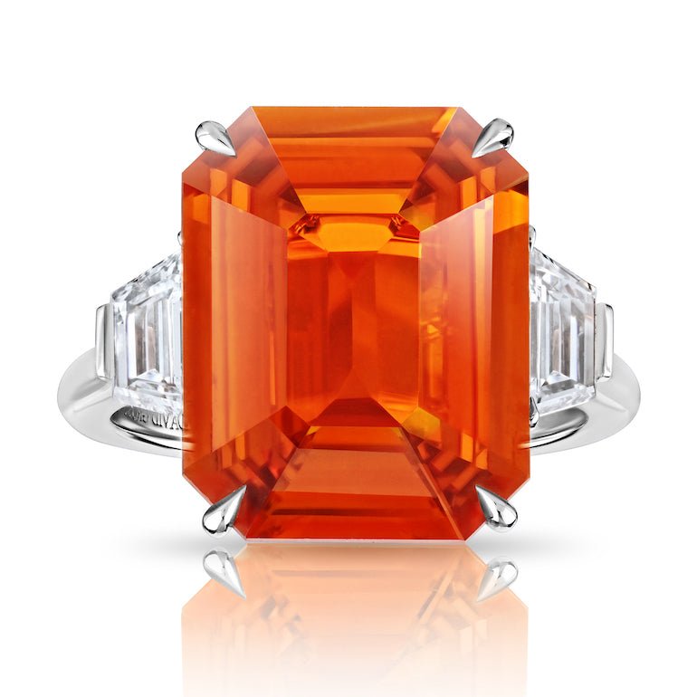 10.53 carat Emerald Cut Orange Sapphire with two Trapezoid Step Cut Diamonds in a Platinum ring