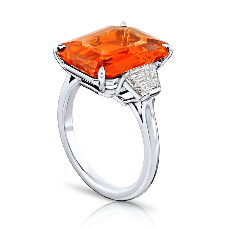10.53 carat Emerald Cut Orange Sapphire with two Trapezoid Step Cut Diamonds in a Platinum ring - David Gross Group