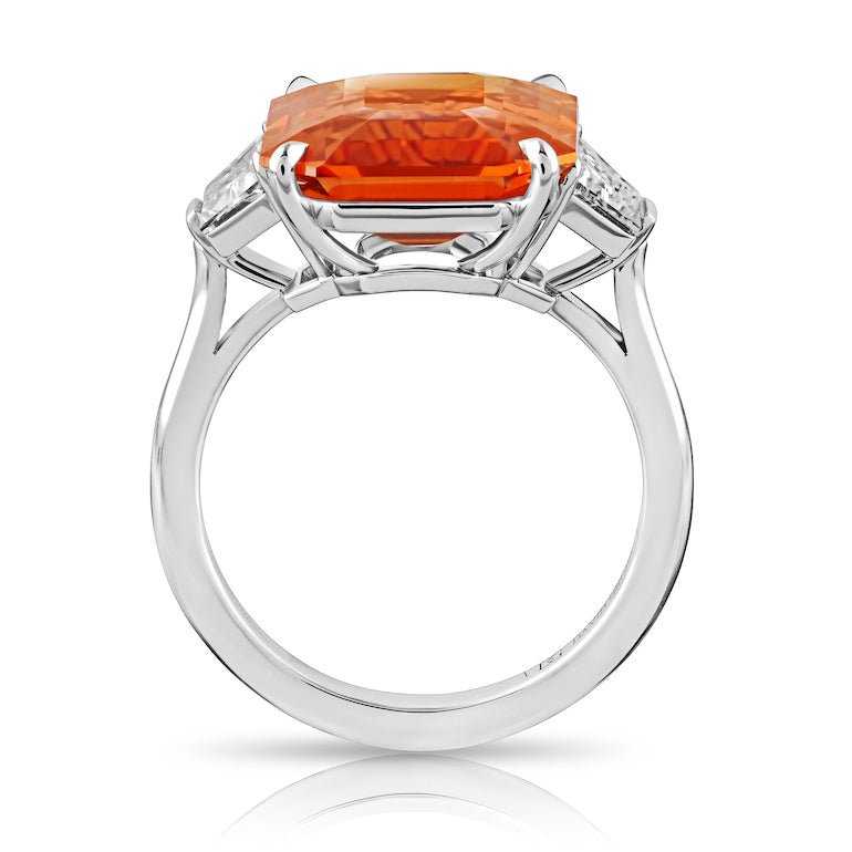 10.53 carat Emerald Cut Orange Sapphire with two Trapezoid Step Cut Diamonds in a Platinum ring - David Gross Group