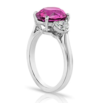 4.49 carat Oval Pink Sapphire with two Heart Diamonds in a Platinum ring - David Gross Group